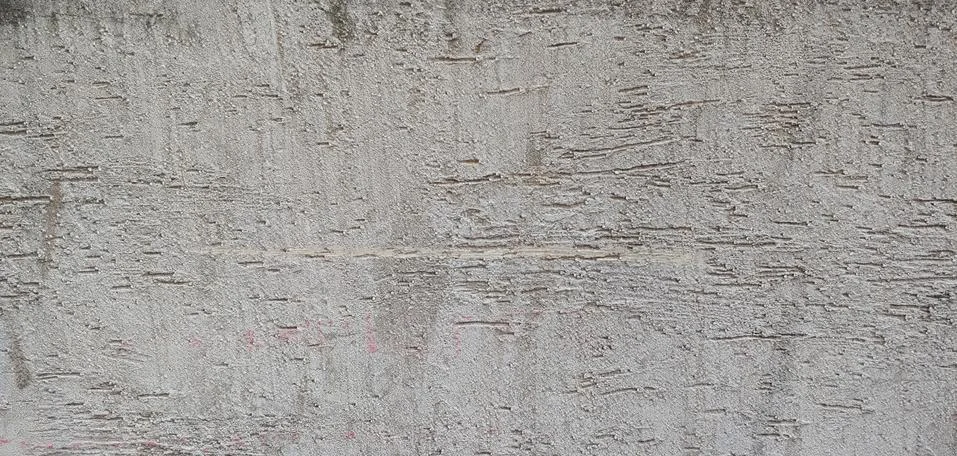 Rough gray wall with roller marks background Stock Photos