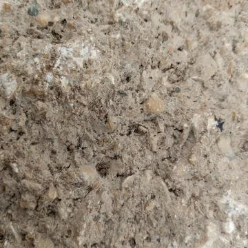 Rough grey concrete stone wall texture tiny pebbles embedded sand Stock Photos