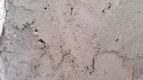 Rough grey concrete wall surface texture in slow motion video clip 스톡 동영상 337844165