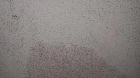 Rough grey concrete wall surface with a textured industrial finish Stock Photos