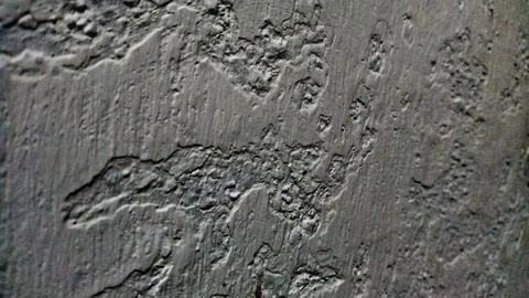 Rough grey concrete wall texture with uneven plaster finish Stock Photos