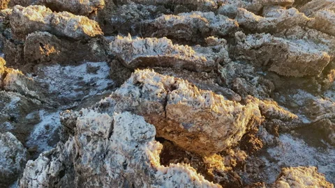 Rough ground with salt with sunset light at Devils Golf course Death Valleyll Stock Footage 217593251