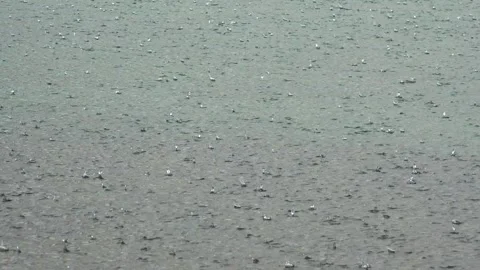 Rough hail impacts water surface during intense rainy storm weather - Ice Rain Stock Footage 339372409