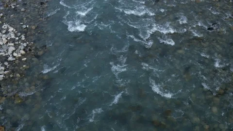 Rough mountain river with adjacent multi-colored tributaries from a 4K drone Stock Footage 123129063