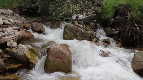 Rough mountain river flows among large stones Stock Footage 108625253