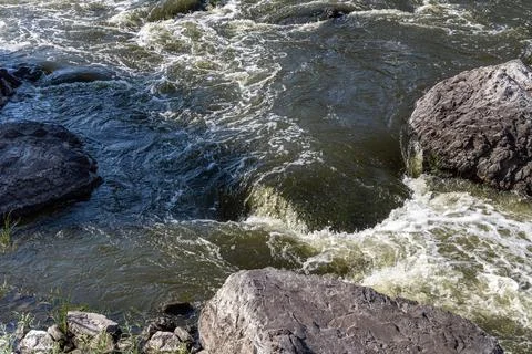 Rough mountain river flows among stones in summer day Foto stock
