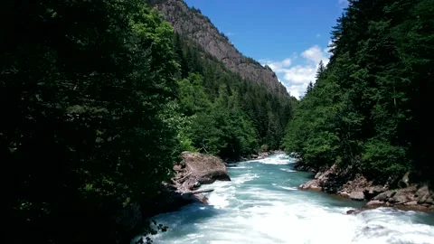 The rough mountain river flows with a powerful stream along the gorge Stock Footage 138691624