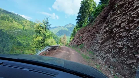Rough mountain road with offroad SUV and sunny view Stock Footage 309323853