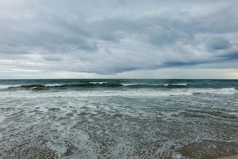 Rough ocean with dramatic dark storm clouds in the shy Stock Photos
