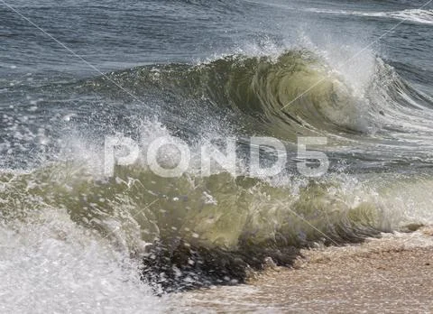 Rough ocean waves breaking on the shore Stock Photos