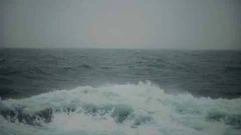 Rough ocean waves breaking in stormy grey weather from a ship Video stock 347823929