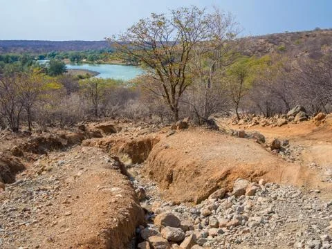 Rough offroad track with large ruts along Kunene River between Kunene River Stock Photos