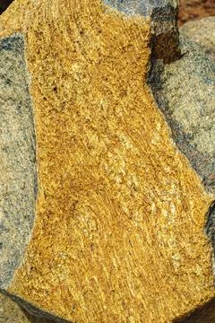 Rough orange rock formation closeup Stock Photos