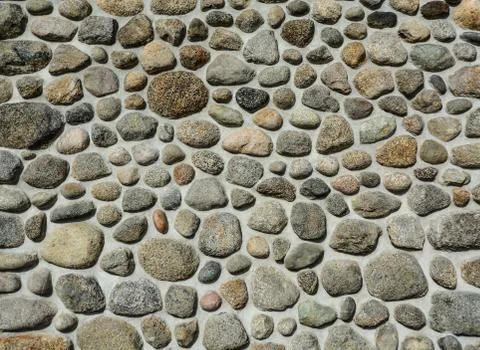 Rough pebble mosaic texture background in cement Stock Photos
