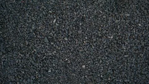 Rough pebble stone texture abstract background. Grainy grey and black rock .. Foto stock