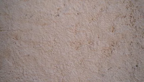 Rough plaster wall texture with aged beige stucco surface Stock Photos