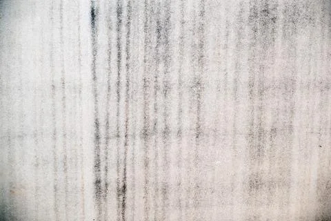 Rough plastered wall with damp vertical patches Stock Photos