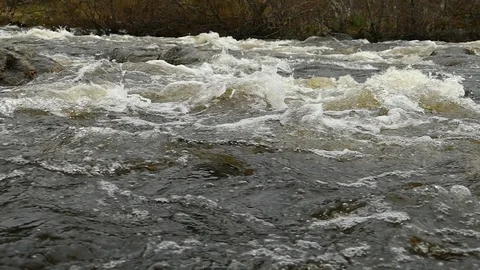 Rough rapid mountain river in early spring, slow motion footage. Stock Footage 102748382