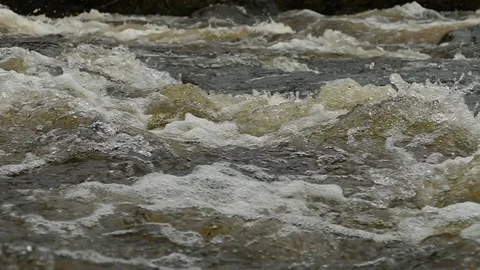 Rough rapid mountain river in early spring, slow motion footage. Stock Footage 102748388