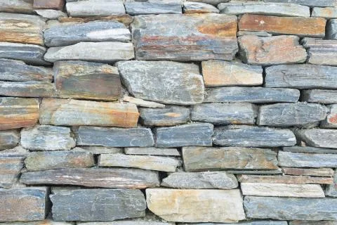 Rough raw stone bricks ancient wall Stock Photos