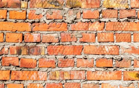 Rough red brick wall as background texture Stock Photos