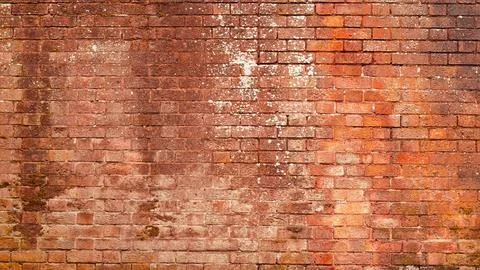 A rough red brick wall with chipped edges and a rustic feel. Stock Photos