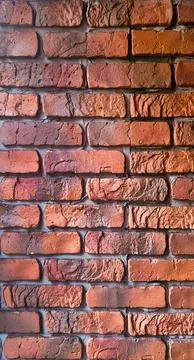 Rough red brick wall texture with visible cement joints Stock Photos