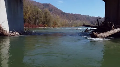 Rough river flying under the bridge over water Stock Footage 142542466