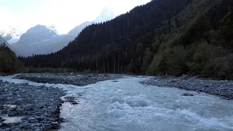 Rough river makes its way through the mountains and the forest Stock Footage 96179645