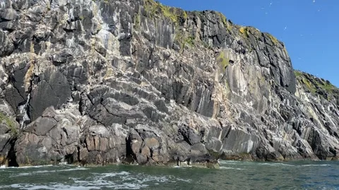 Rough rocks and cliffs tower over the turbulent sea with a natural panorama Stock Footage 287134588