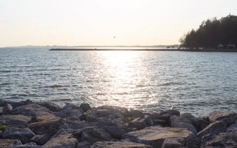 Rough rocks and wave surface with sunset Stock Photos