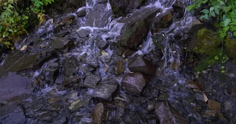 Rough rocks of a waterfall panning up in a forest of Utah Valley Stock Footage 120211366