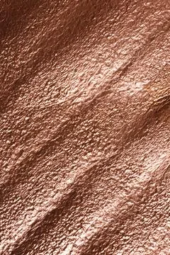 Rough rose gold surface as background, top view Stock Photos