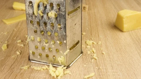Rough rubbing cheese on a grater Stock Footage 119124183