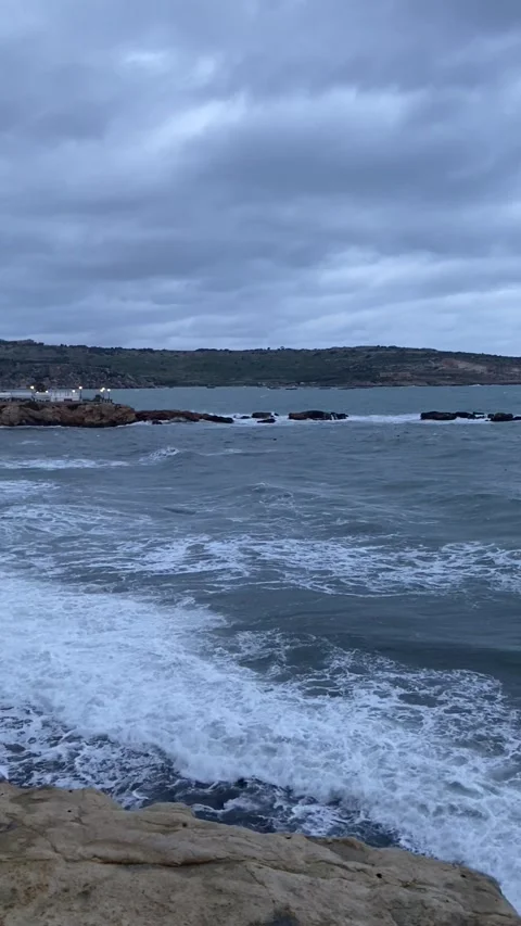 Rough sea and cloudy sky facing Saint Pauls Island in Malta Stock Footage 310787148