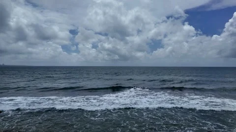 Rough Sea Under Cloudy Sky in Okinawa with Gentle Panning Shot Stock Footage 325652280