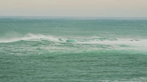 Rough Sea Waves and Rocky Outcrop on an Overcast Day Stock Footage 320229249