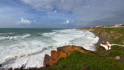 Rough sea with waves breaking against rocks in the Portuguese coastline Stock Footage 254975771
