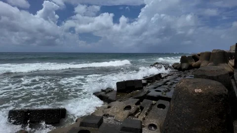 Rough Sea Waves Breaking Along Rocky Coast Under Overcast Sky 4K Stock Footage 325654146