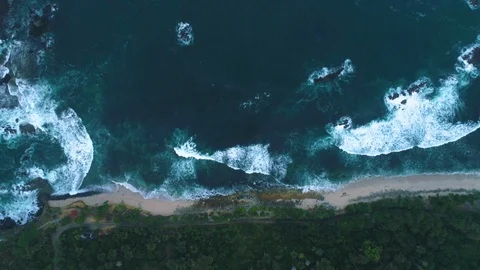 Rough sea waves hitting rocks slow motion capture an aerial view Stock Footage 92048371