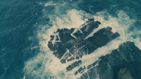Rough sea waves hitting rocks slow motion capture an aerial view Stock Footage 92051590