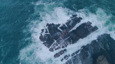 Rough sea waves hitting rocks slow motion capture an aerial view Stock Footage 92052342
