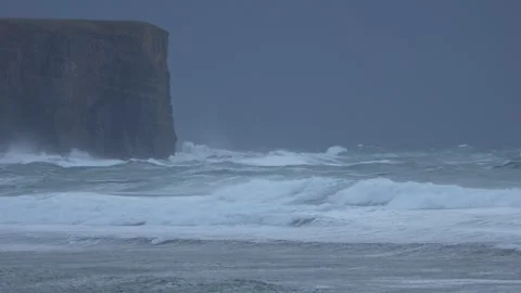 Rough seas at the bottom of a cliff in 4k Stock Footage 292684020