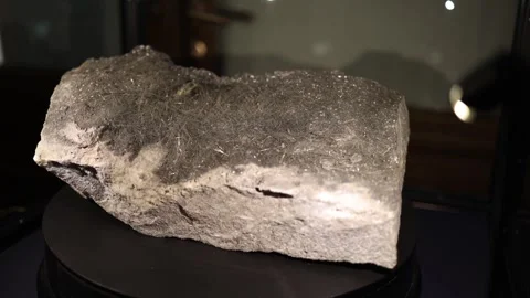 Rough specimen of a mineral with fine needle-like crystal inclusions, adding a u Stock Footage 289636541