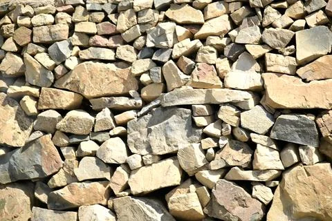 Rough stacked stone wall background texture Stock Photos