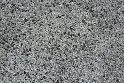 Rough stone aggregate plaster on a building wall texture Stock Photos
