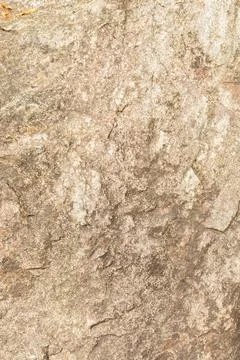 Rough stone surface with various textures and colors is seen in natural light Stock Photos
