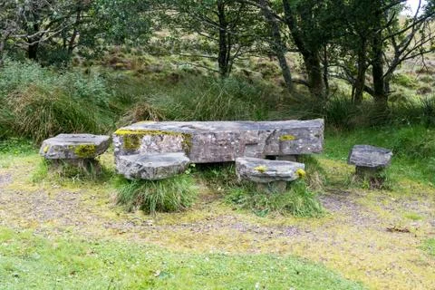 Rough stone table and chairs at parking of Knockan Crag in North West Highlan Stock Photos