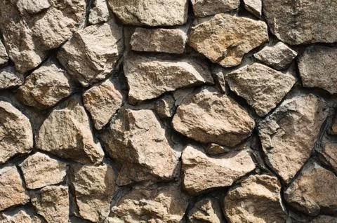 Rough stone wall background Stock Photos