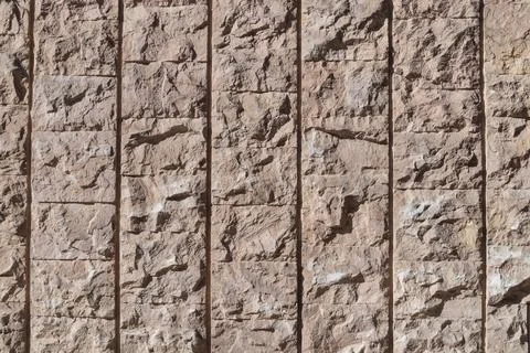 Rough stone wall with rectangular patterns, showcasing natural textures and.. Stock Photos
